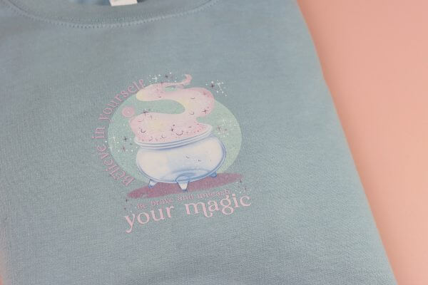 Enchanted Wands & Wishes - 'Believe in yourself' Glass Cauldron illustrated sweater -BLUE